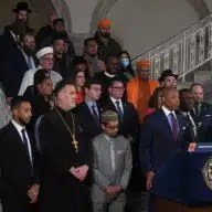 Mayor Adams with faith leaders at City Hall rotunda speaking about hate crimes