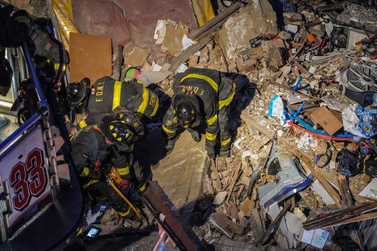 Firefighters comb the rubble of the Bronx collapse site