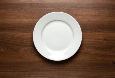 White empty plate at the table