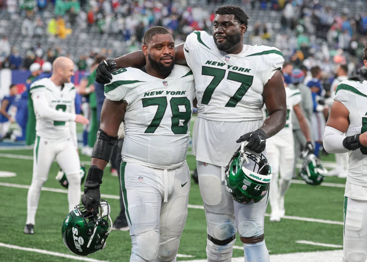 New York Jets guard Laken Tomlinson (78) and offensive tackle Mekhi Becton (77) walk off the field after defeating the New York Giants in overtime at MetLife Stadium.