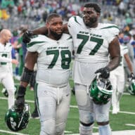 New York Jets guard Laken Tomlinson (78) and offensive tackle Mekhi Becton (77) walk off the field after defeating the New York Giants in overtime at MetLife Stadium.