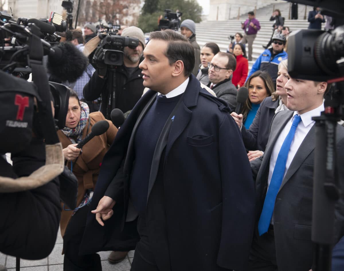 George Santos before crowd of reporters