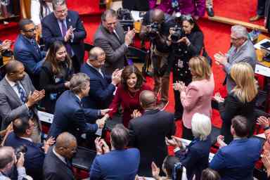 Governor Kathy Hochul shakes hands with New York lawmakers at the 2024 State of the State Address on Jan. 9, 2024 in the Assembly chamber