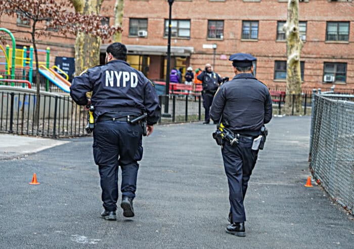 Police walk through East Harlem shooting scene
