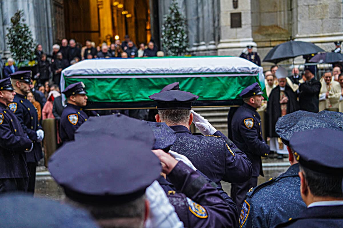 Police officers carry the casket of former Chief of Department Joseph Esposito