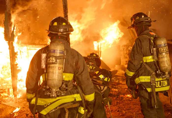Firefighters in front of flames at Brooklyn fire