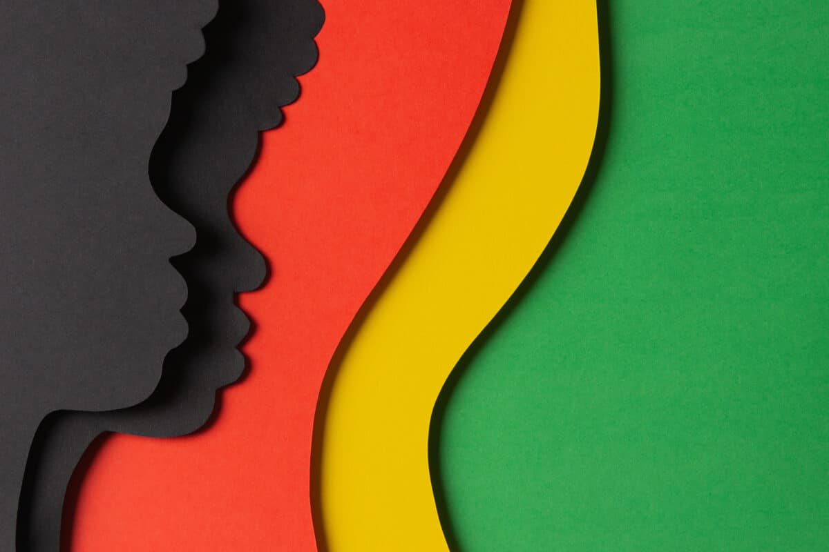 Black History Month color background. African Americans history celebration. Abstract geometric red, yellow, green color background with black paper cut people silhouette. Top view