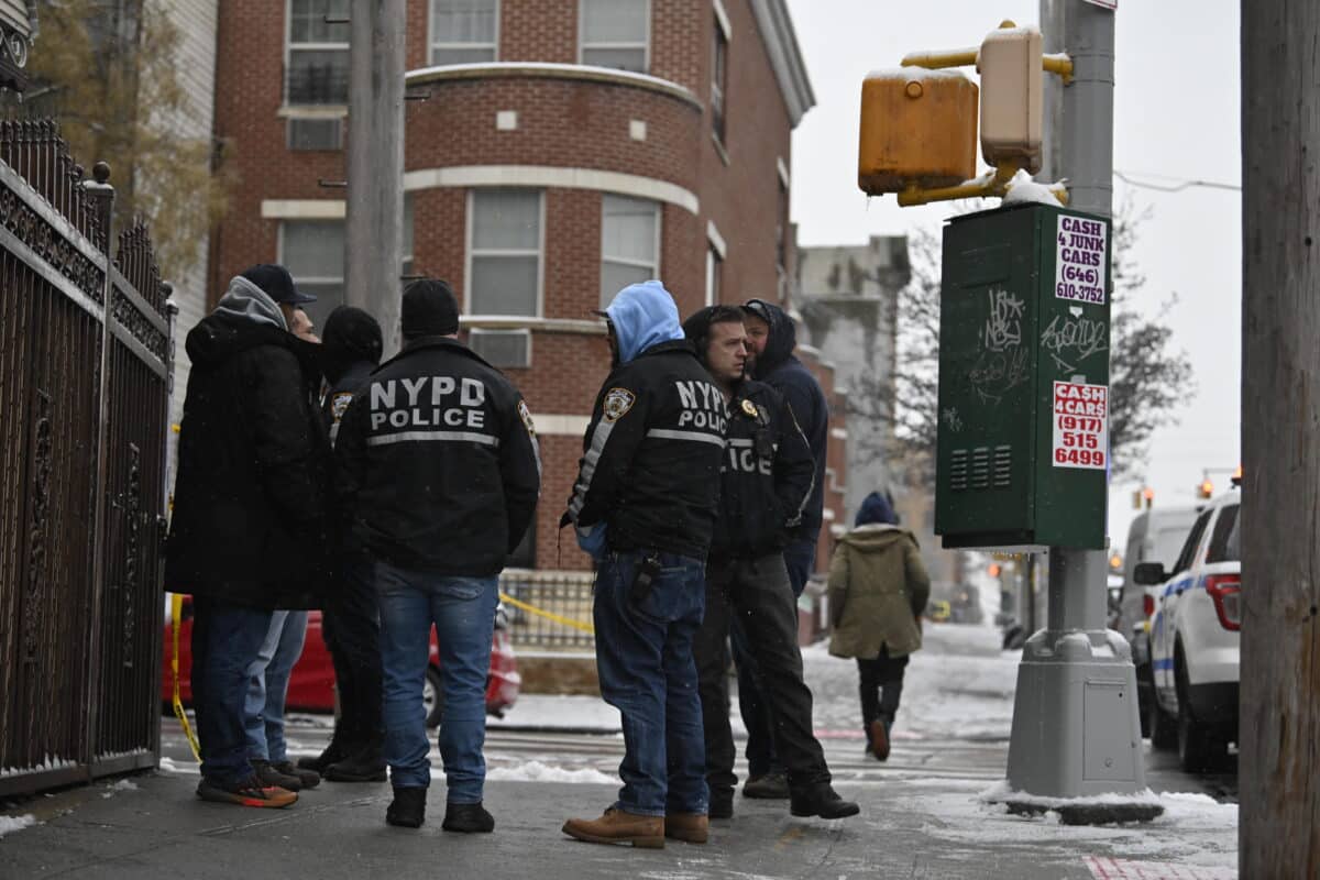 Police huddle after Brooklyn shooting