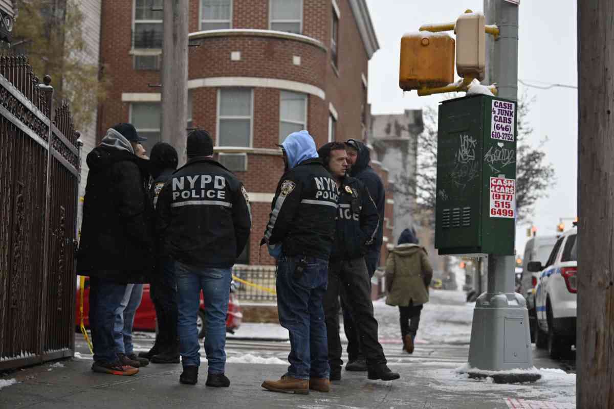 Police huddle after Brooklyn shooting