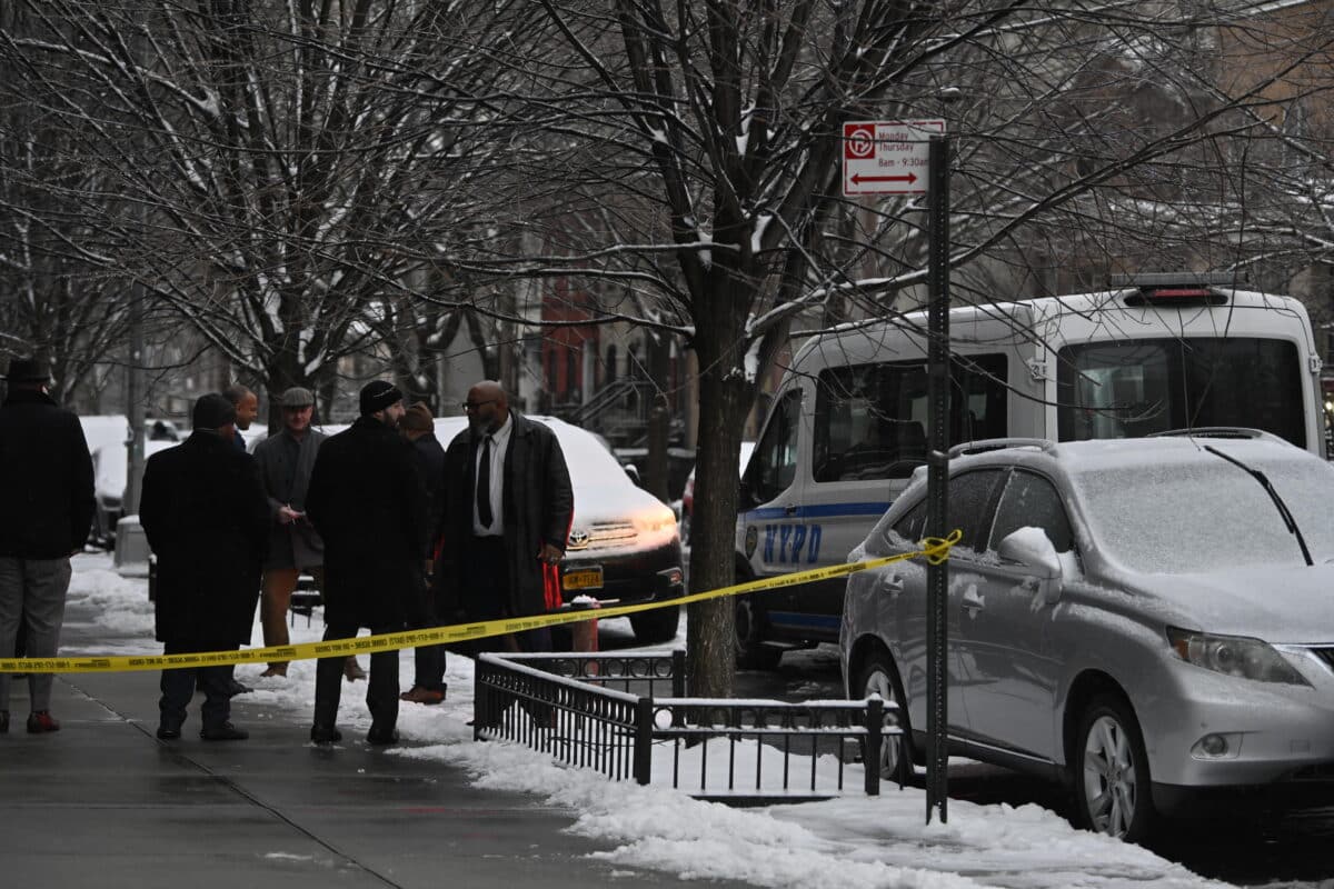 Police huddle after Brooklyn shooting