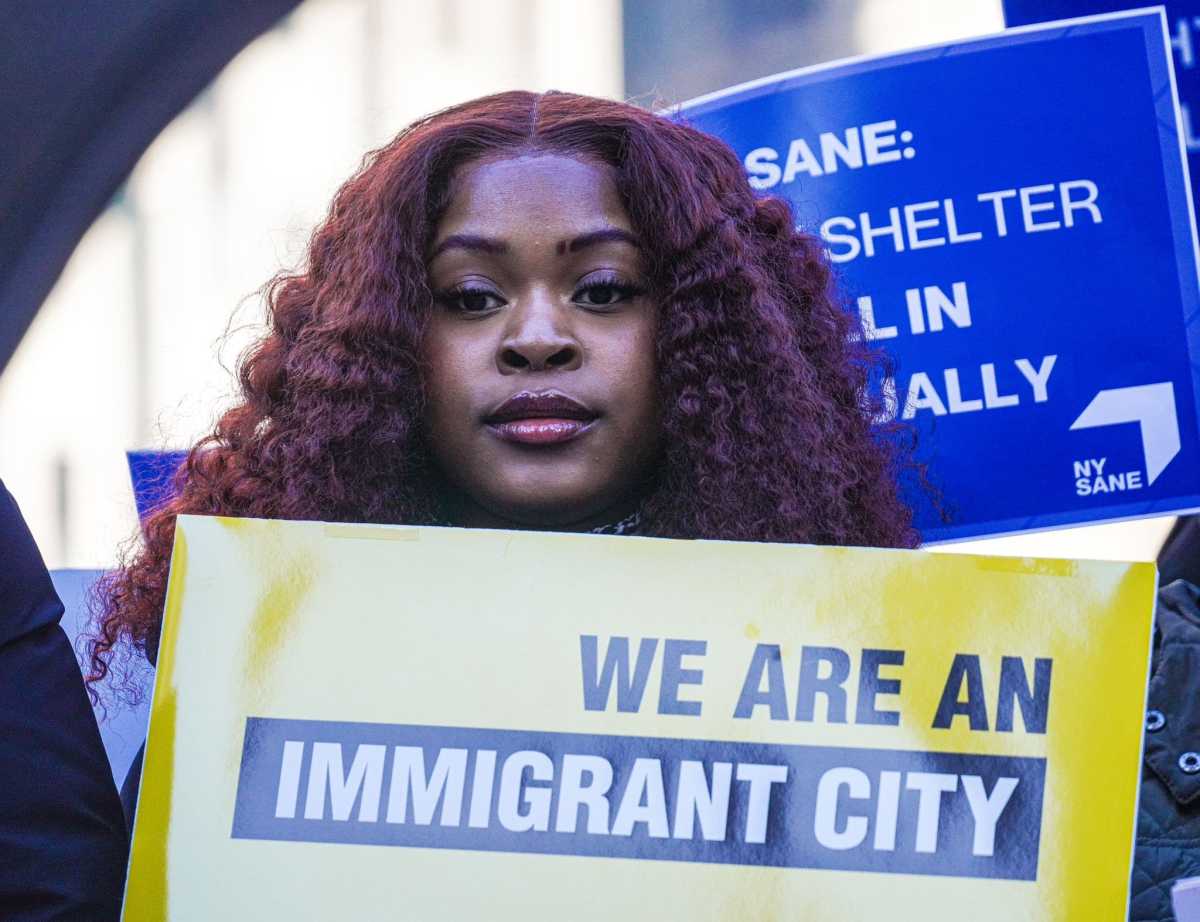 An advocate holds a sign reading: "We are an immigrant city."