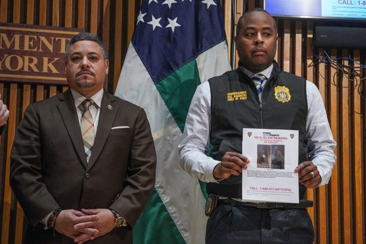 Police Commissioner Caban with officer holding wanted poster of Queens stabbing suspect