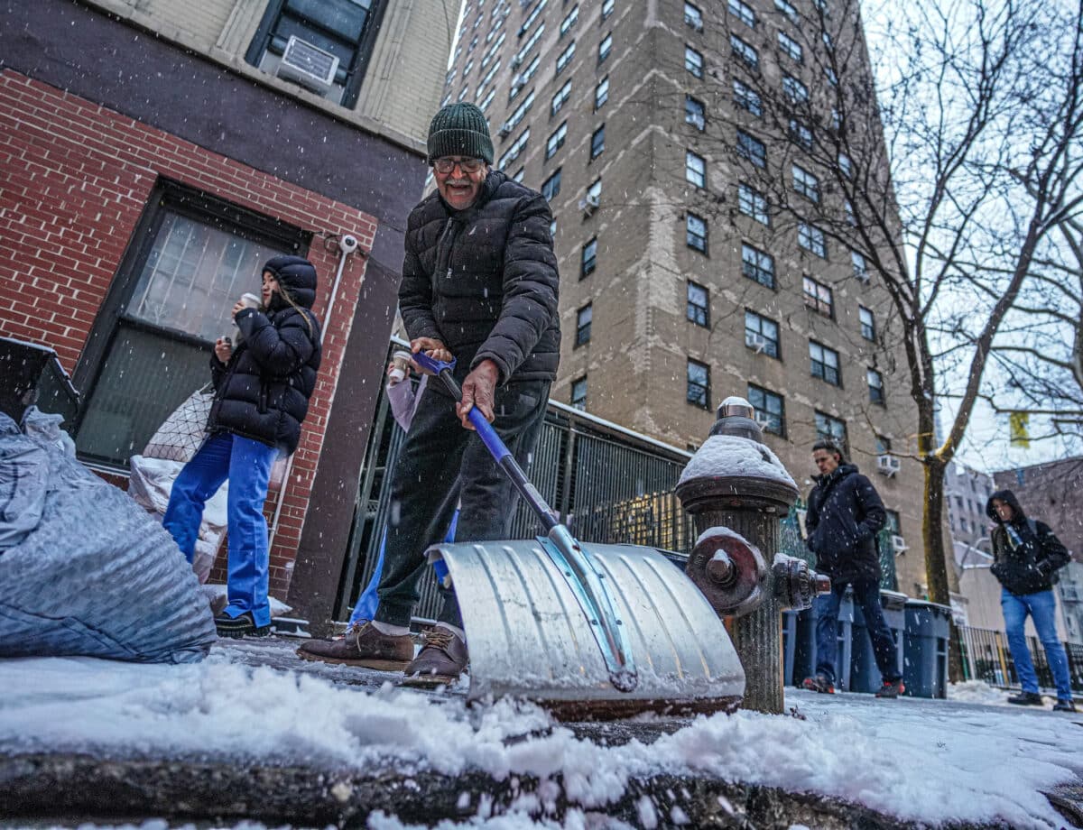 New Yorker shovels snow during storm that broke snowless streak