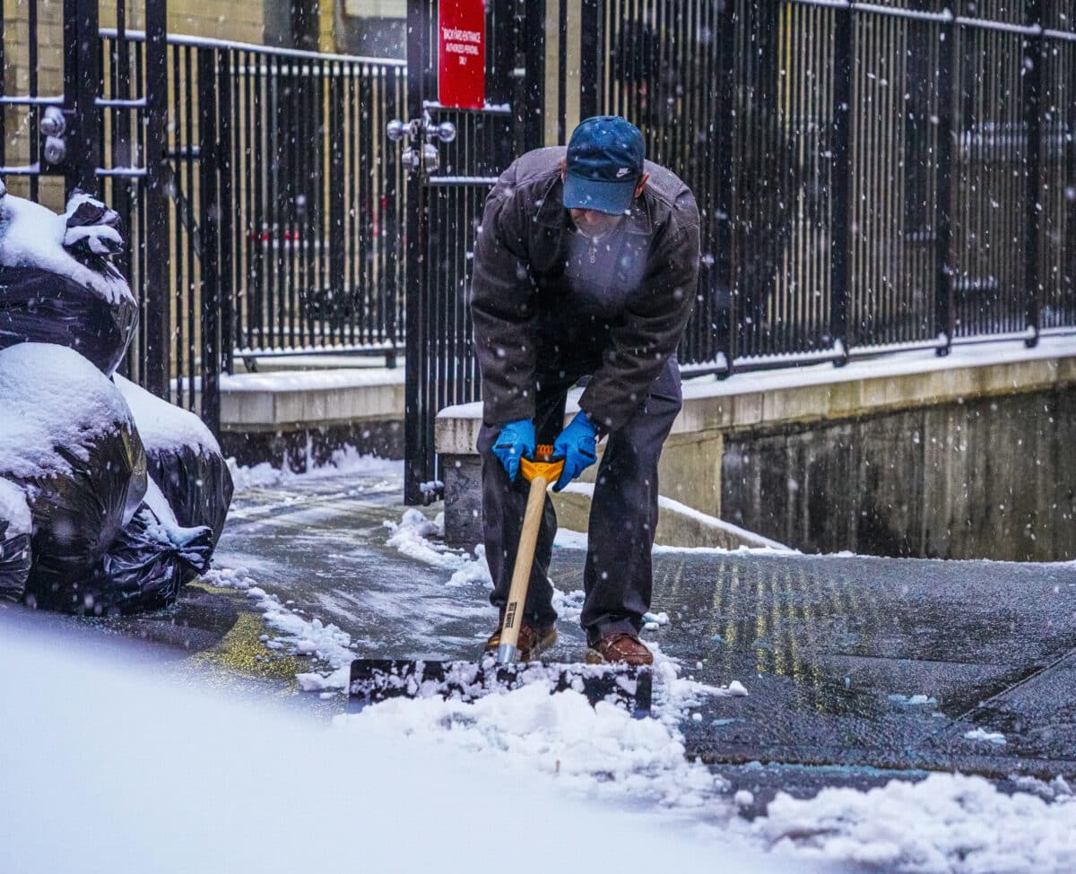 New Yorker shovels snow during storm that broke snowless streak