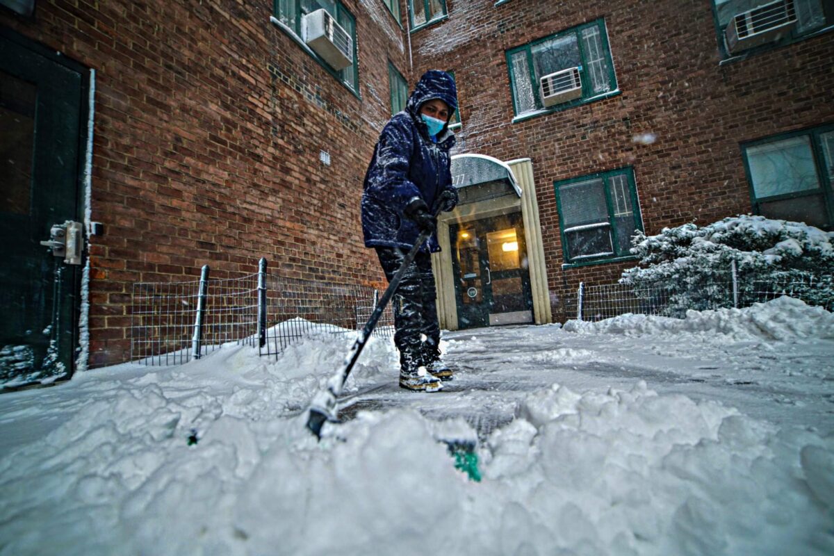 New York resident shoveling snow off path