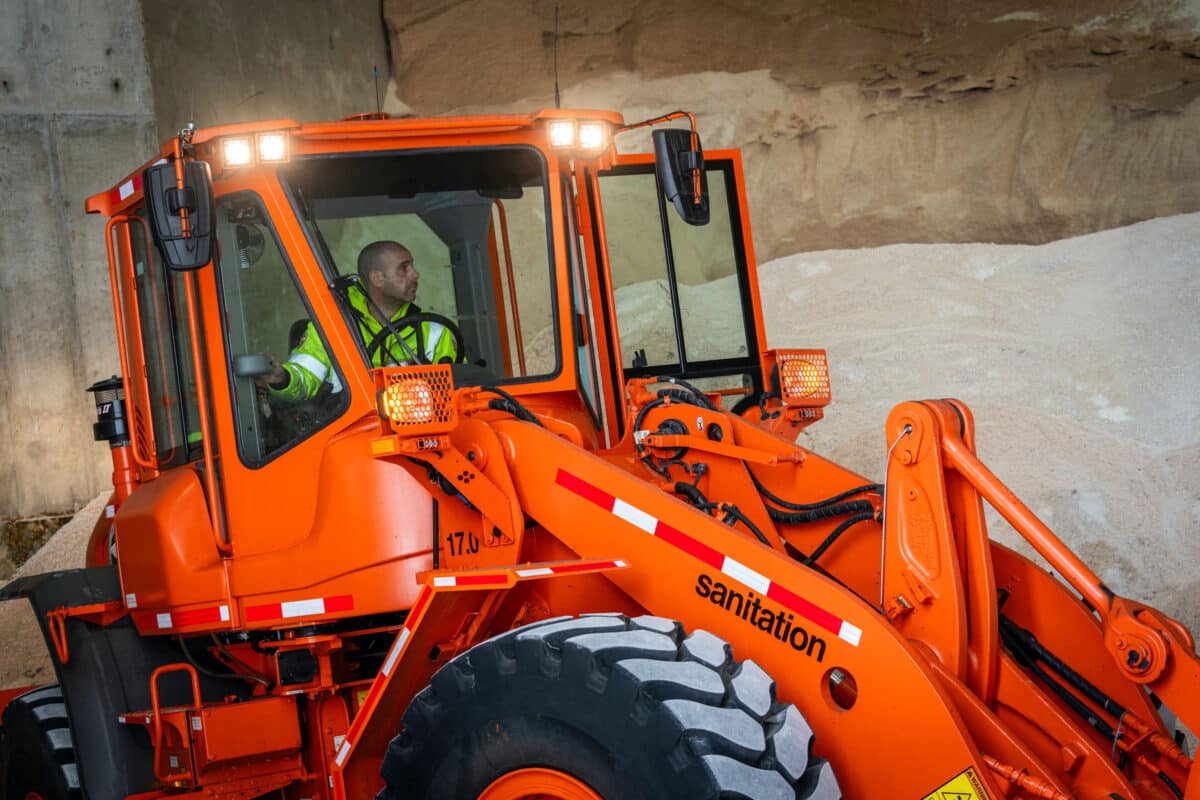 Winter storm preparation, sanitation frontloader loads salt