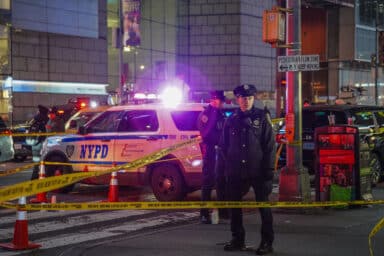 Bullets flew inside a store in Times Square on Thursday night during an shooting that left one woman injured.
