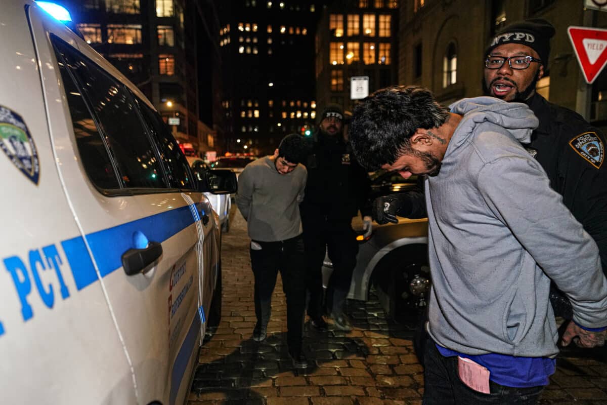 Migrant crime ring member arrested and escorted into NYPD vehicle