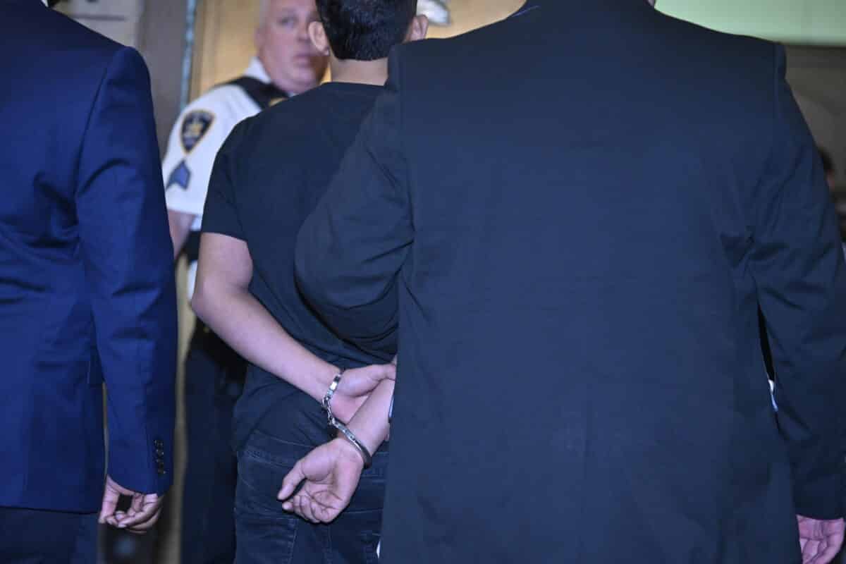 Times Square shooting suspect from behind, in handcuffs