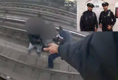 Screenshot of video showing Manhattan transit cops rescue man off tracks