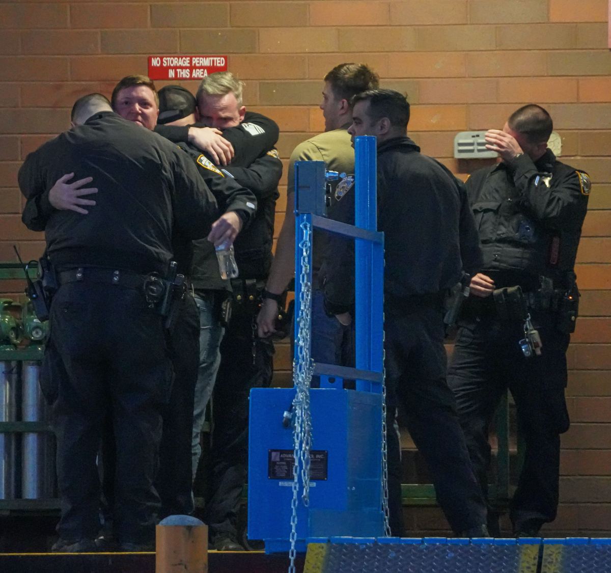 Officers weep outside hospital