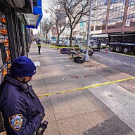 Officer looks at scene of Harlem double stabbing