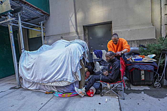 Homeless hairstylist cuts hair of unhoused man