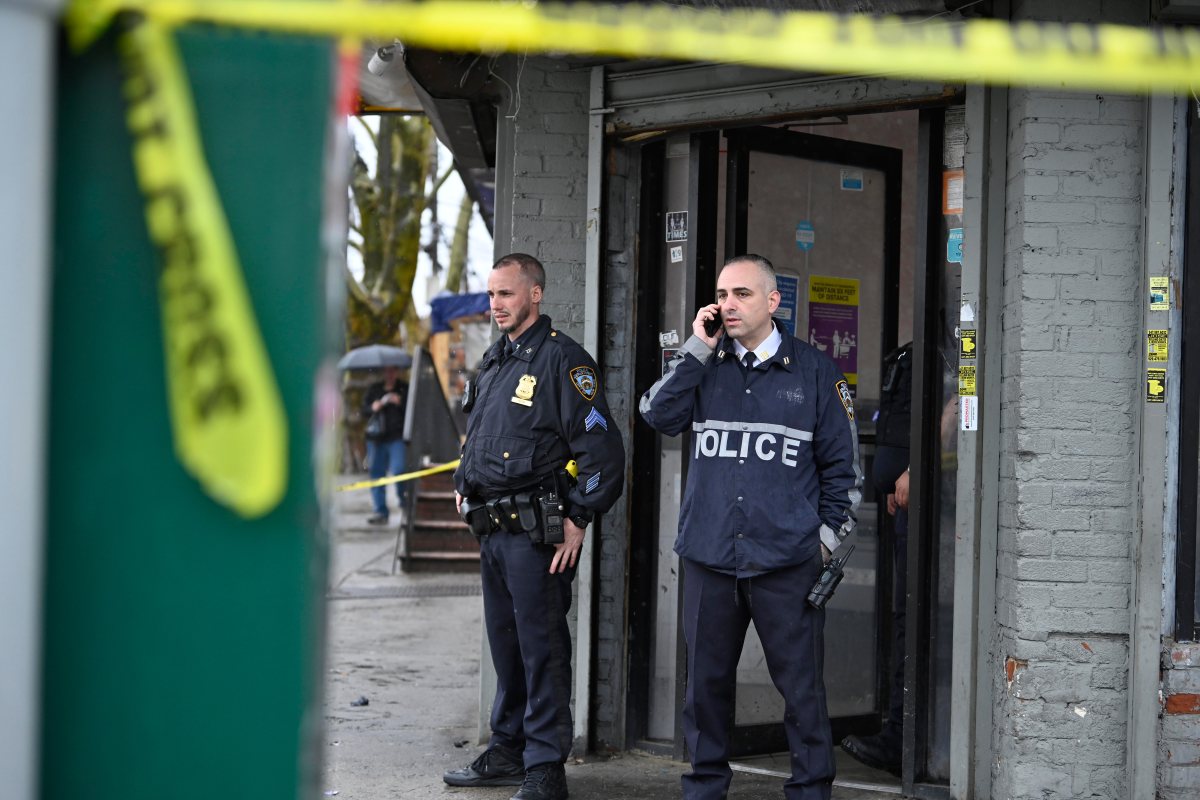 Police officer on phone at Brooklyn shooting scene