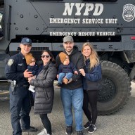 Photo of slain officer Jonathan Diller with family in front of NYPD vehicle