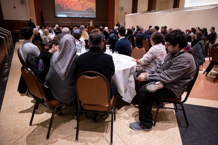 Attendees watch Islamic call to prayer at Jewish temple during interfaith Iftar