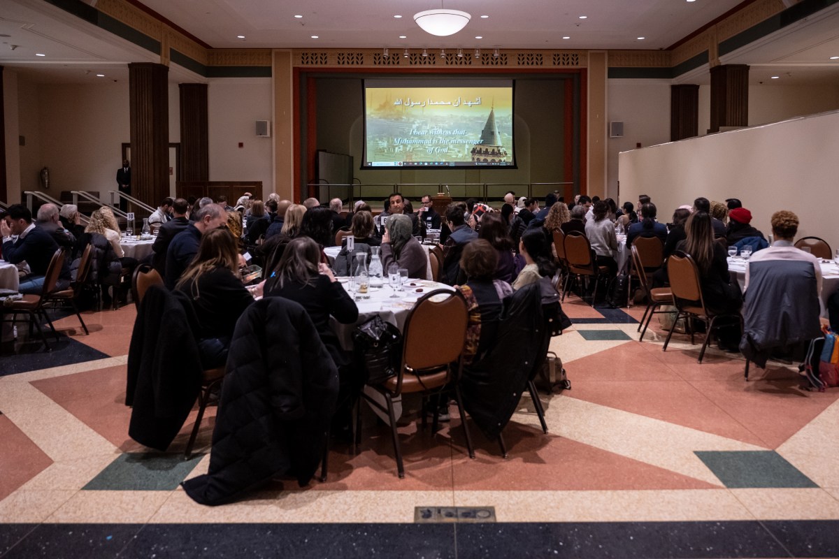 Attendees watch Islamic call to prayer at Jewish temple during interfaith Iftar