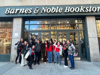 a group of people standing in front of a Barnes & Noble store