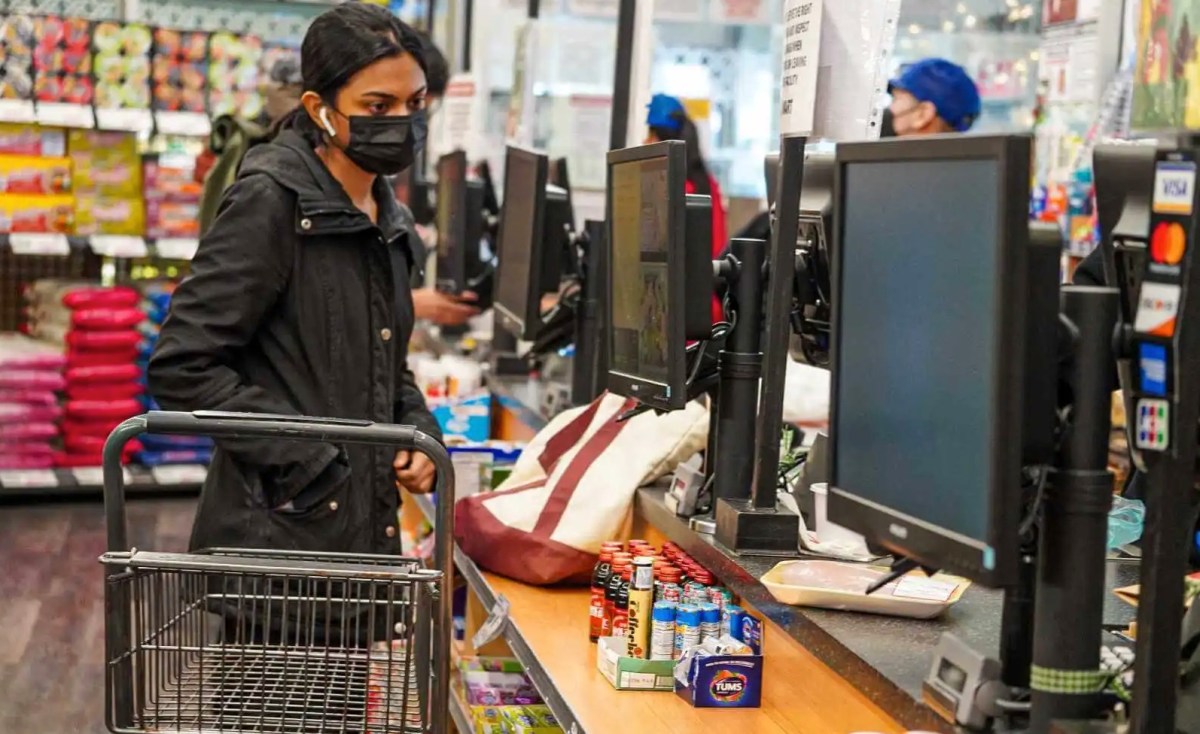 Food shopper at grocery store checkout line