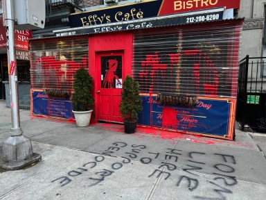 facade of Effy's Cafe with antisemitic graffiti on the sidewalk
