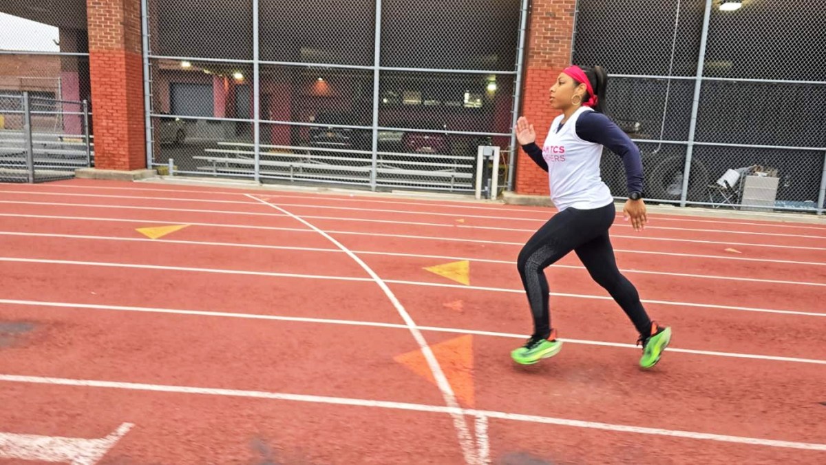 a woman, Krystal Worthy, running on a track. She's a Department of Education employee preparing for the Boston Marathon