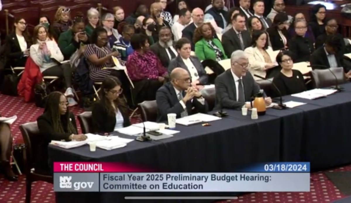 a panel of officials at a meeting regarding nyc education budget cuts