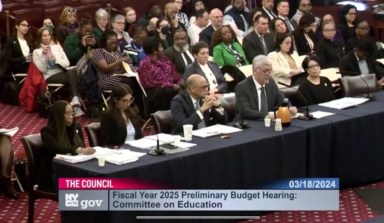 a panel of officials at a meeting regarding nyc education budget cuts