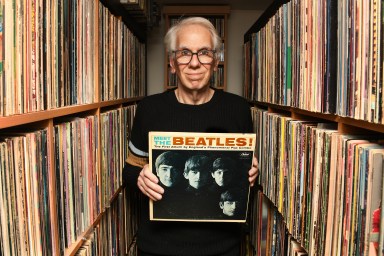 Ira Robbins of Trouser Press holding up copy of Beatles LP