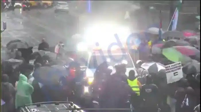 Screenshot of protesters blocking NYPD emergency vehicle in Midtown