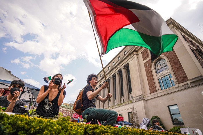 Protester at Columbia University waves Palestine flag