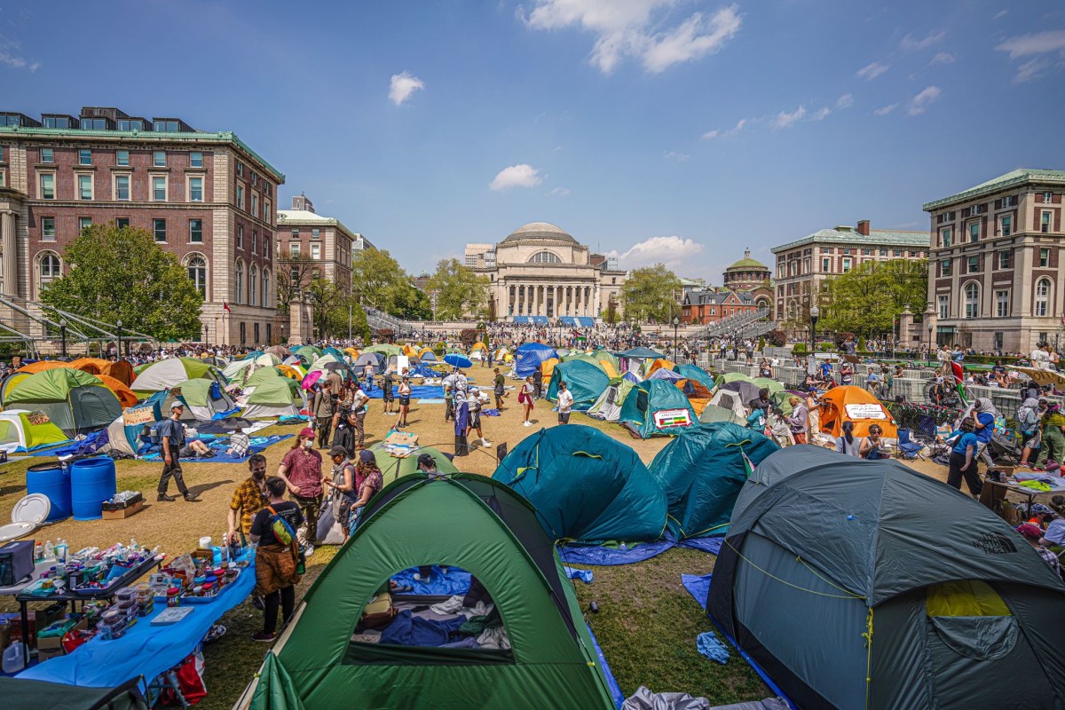 Faculty and staff interlocked their arms and formed a human barricade at the entrance to the tent site.