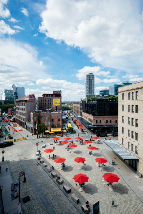 several open red umbrellas set up in the Meatpacking District