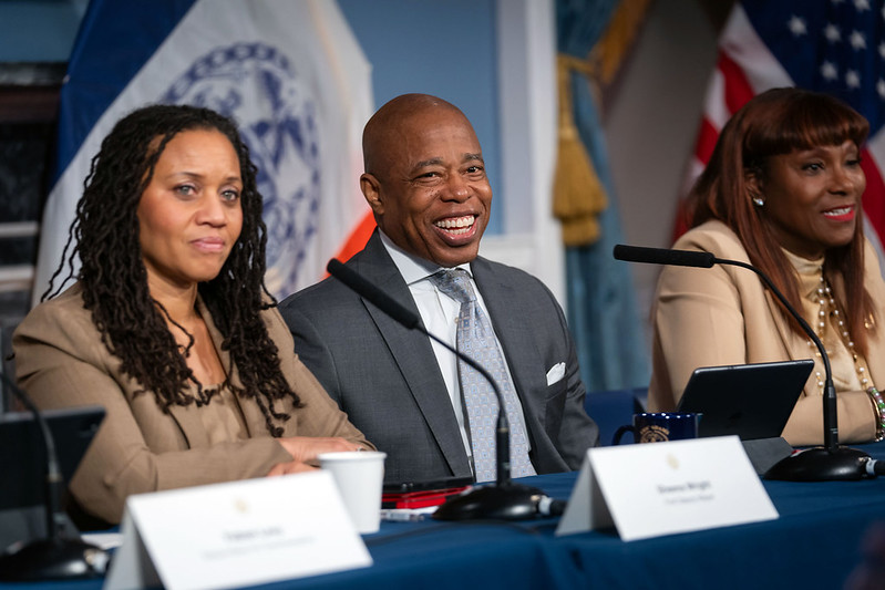 Mayor Eric Adams smiles at briefing