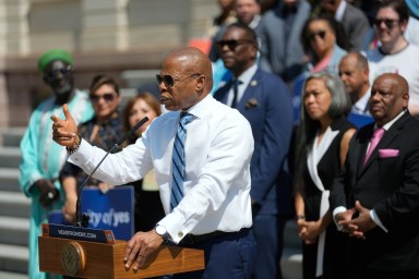 Mayor Adams in sunglasses speaking at rally