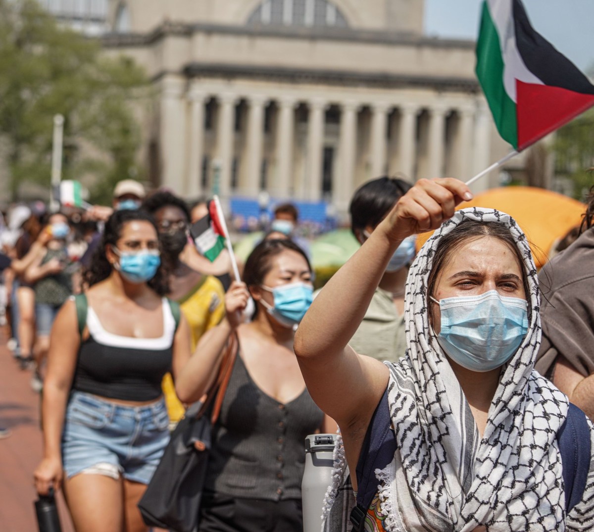 Faculty and staff interlocked their arms and formed a human barricade at the entrance to the tent site.