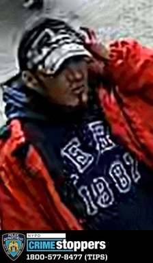 man wearing red jacket, wanted for stabbing a man in Lower East Side Manhattan