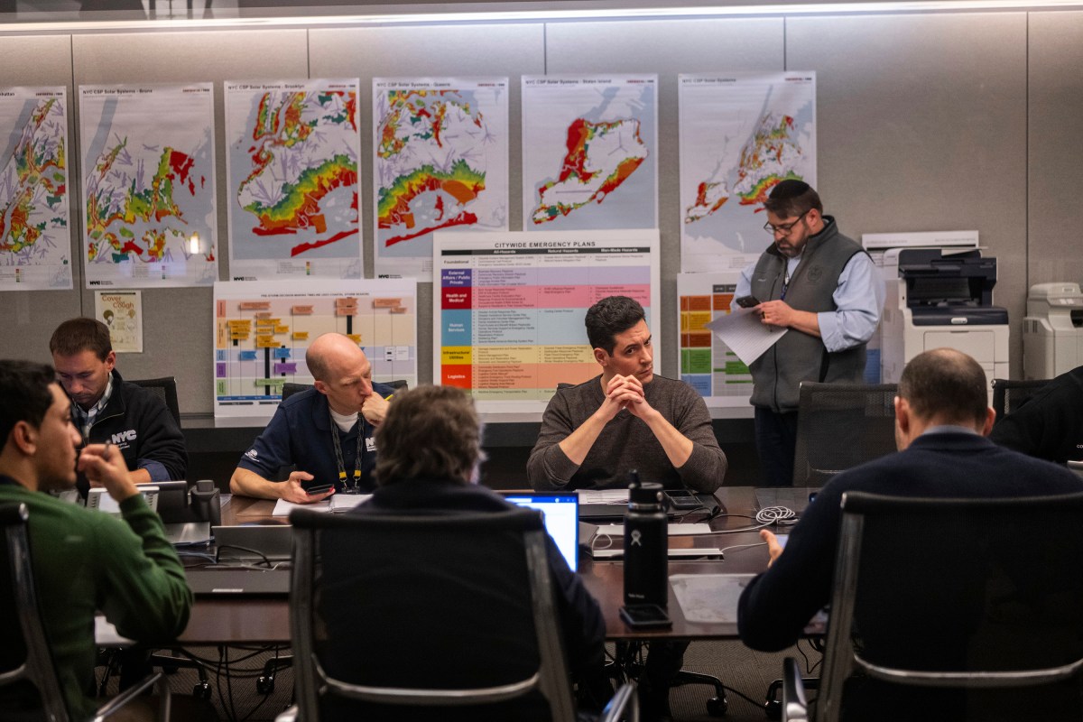 Emergency Management workers at table discuss earthquake