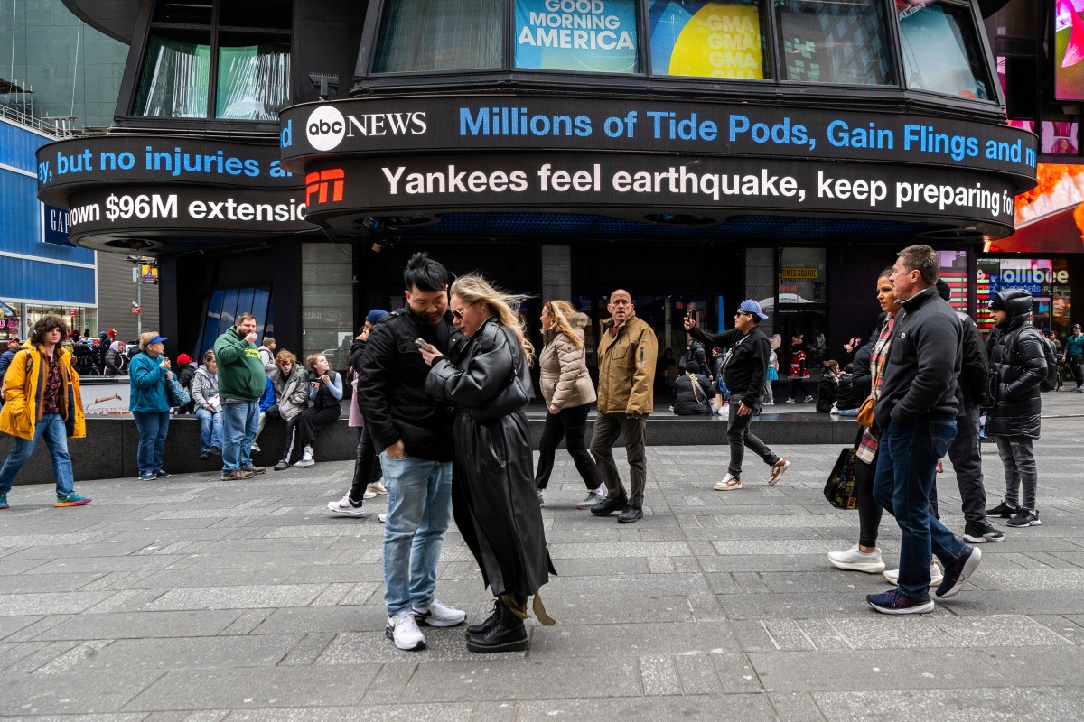 New Yorkers look at phones after earthquake