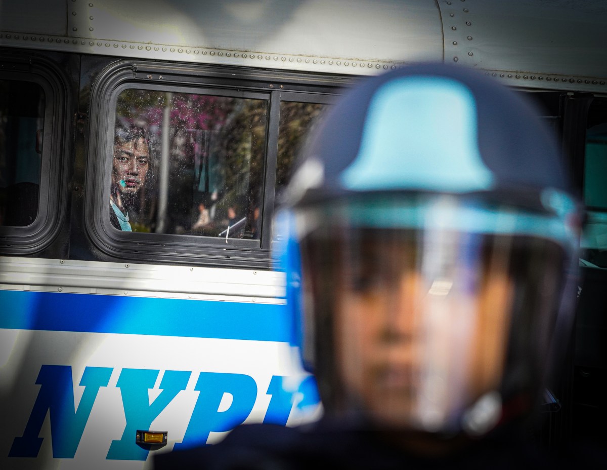 A police officer in front of arrested climate protesters in Tribeca