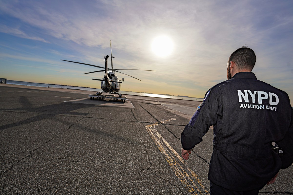 Police officer approaching an NYPD helicopter